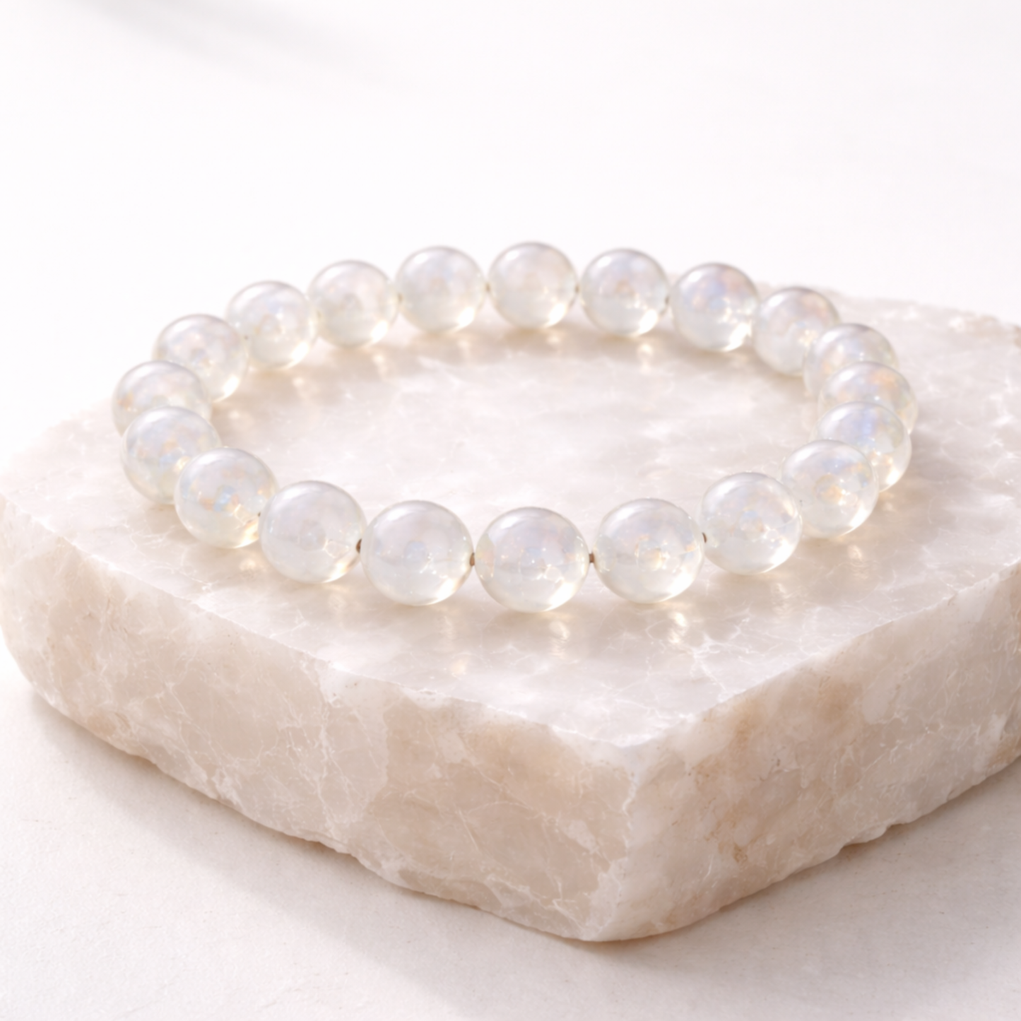 Moonstone crystal bracelet displayed on natural stone base