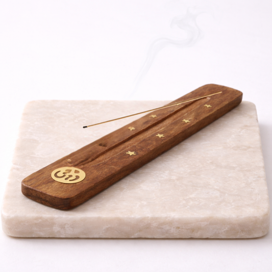 Om incense holder elm wood with incense stick on beige stone slab