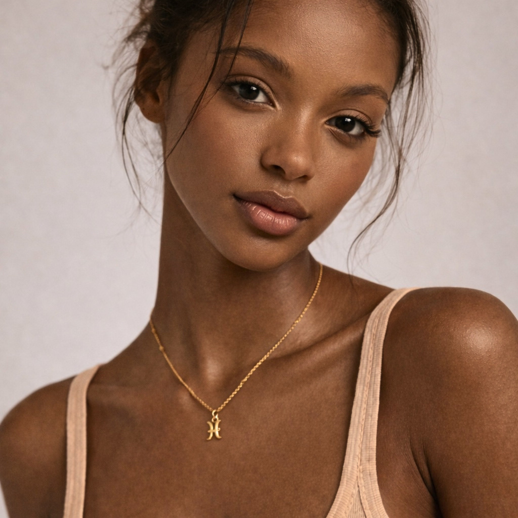 Pisces zodiac necklace gold close up on model showing pendant