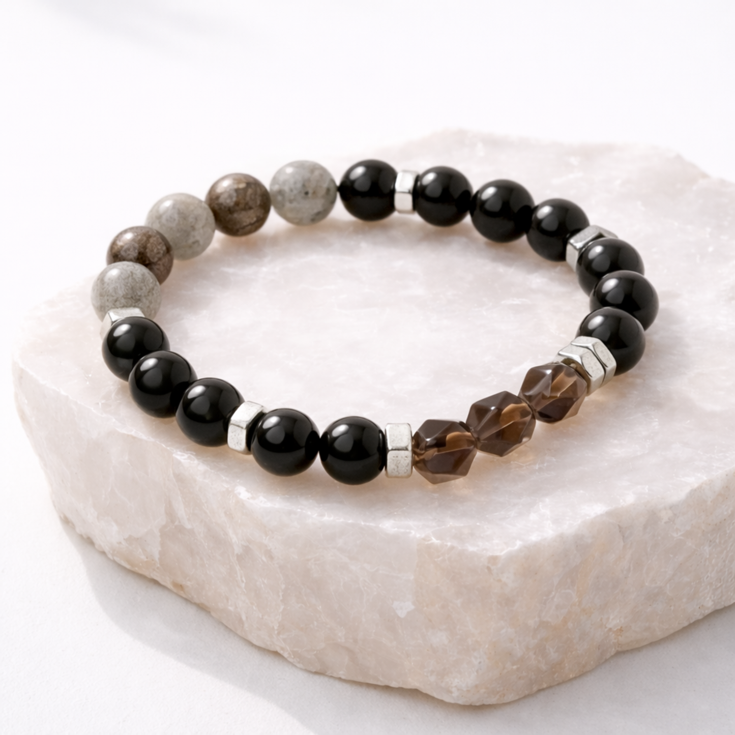 Protection crystal bracelet with labradorite, pyrite, obsidian and smoky quartz on natural stone base