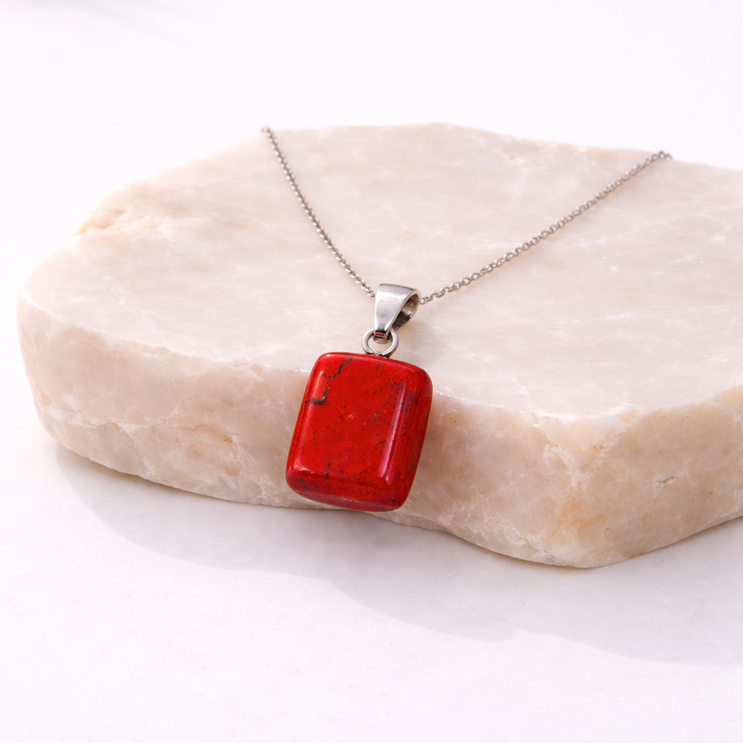 Red jasper necklace square red stone pendant on beige stone slab