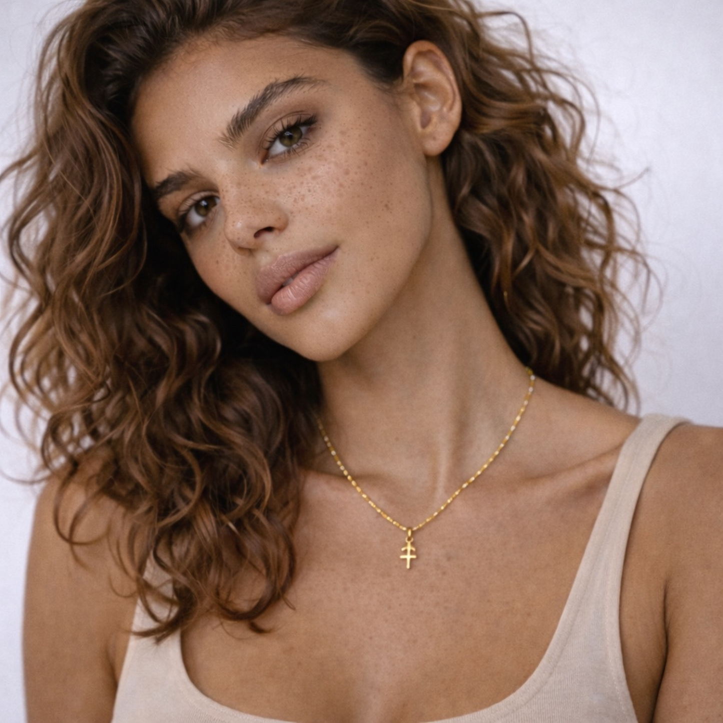 Sagittarius zodiac necklace gold worn on model seated pose