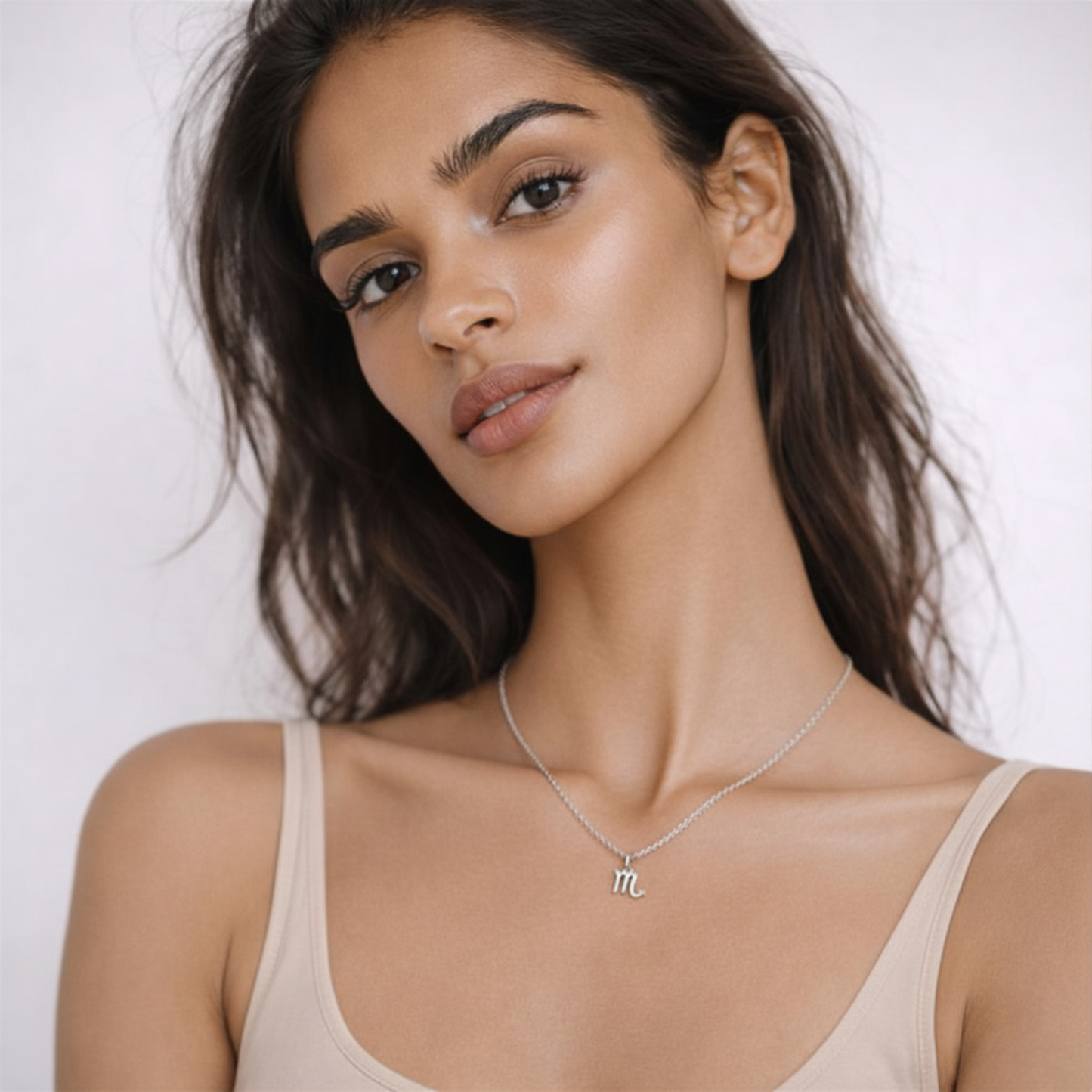 Scorpio zodiac necklace silver worn on model with beige top