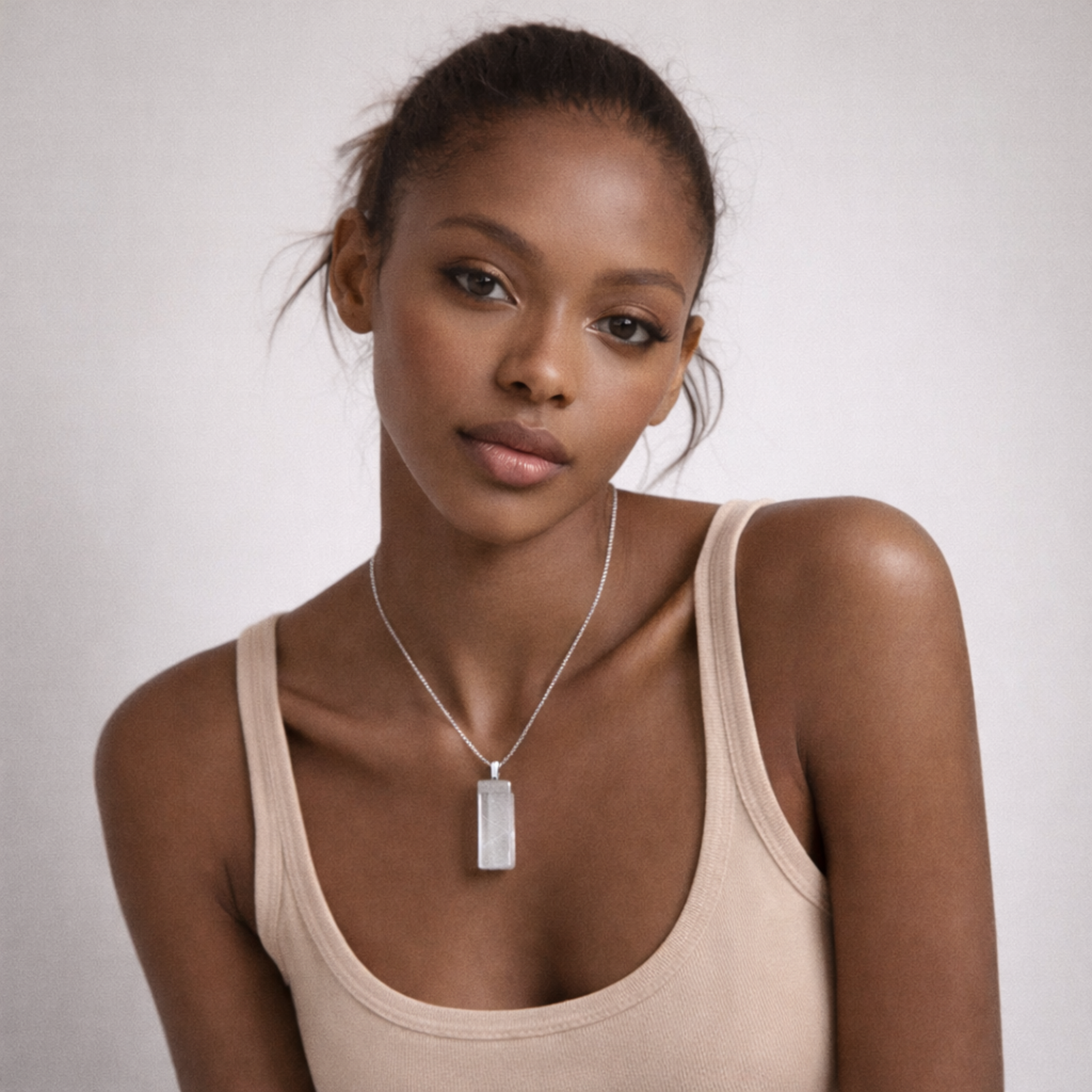 Selenite necklace close up on model showing rectangular white crystal pendant