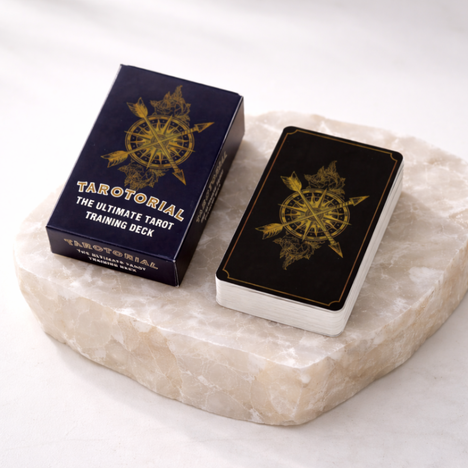 Tarotorial tarot training deck box and card stack showing card back design on beige stone slab