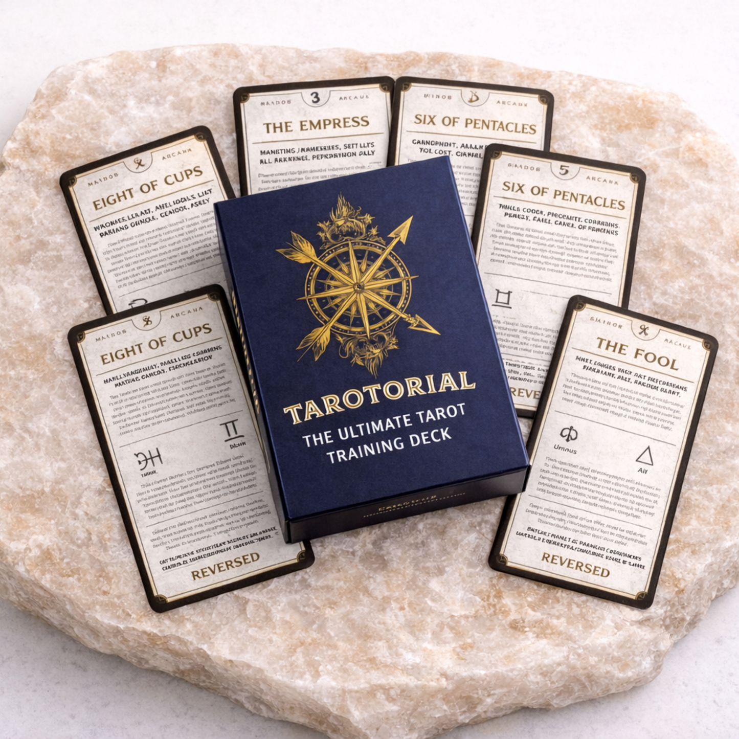 Tarotorial tarot training deck box with multiple cards spread on beige stone slab