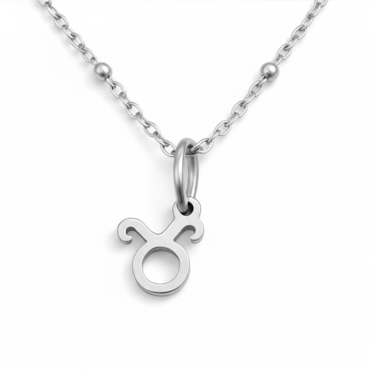 Taurus zodiac necklace silver pendant on silver chain close up