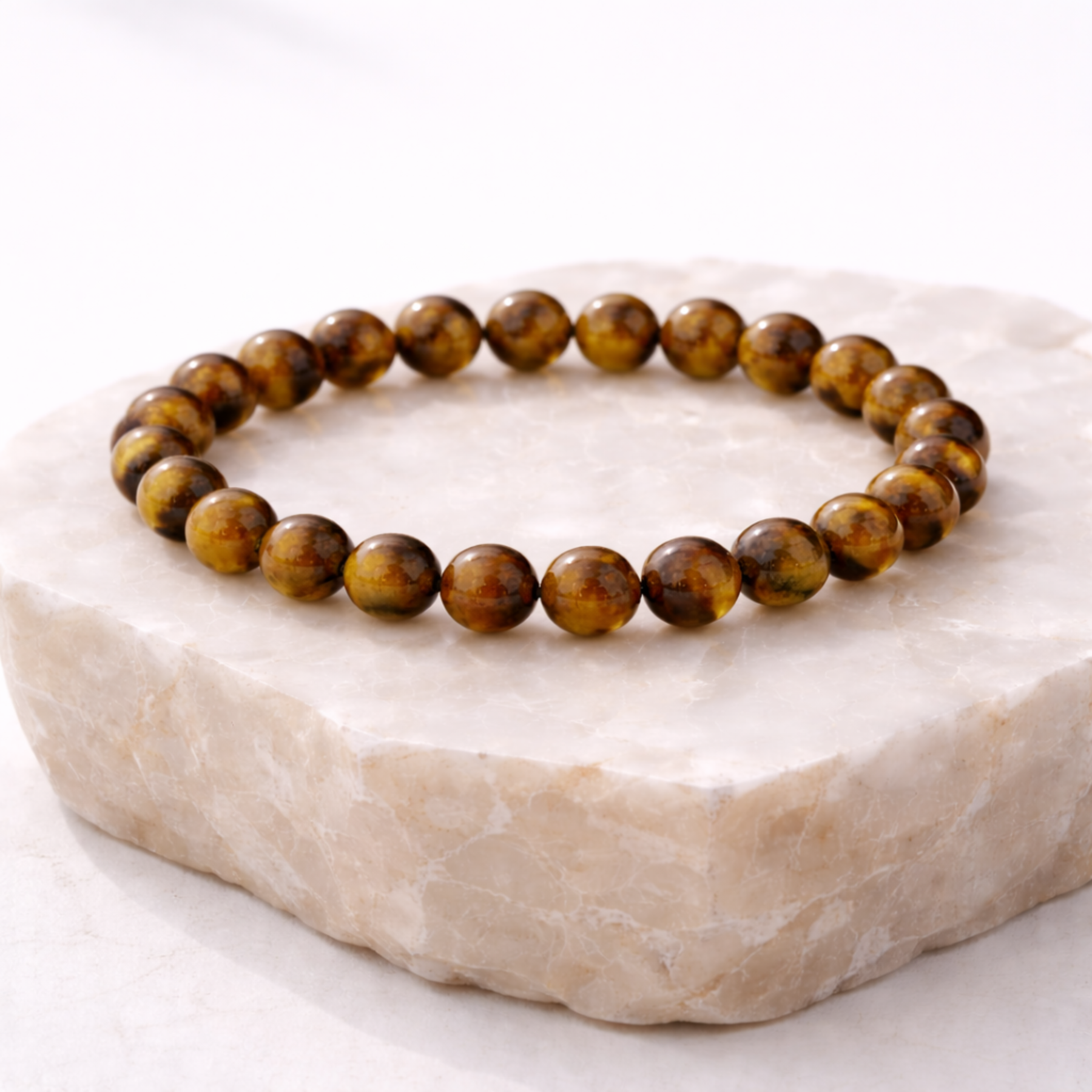 Tiger’s eye crystal bead bracelet on stone base