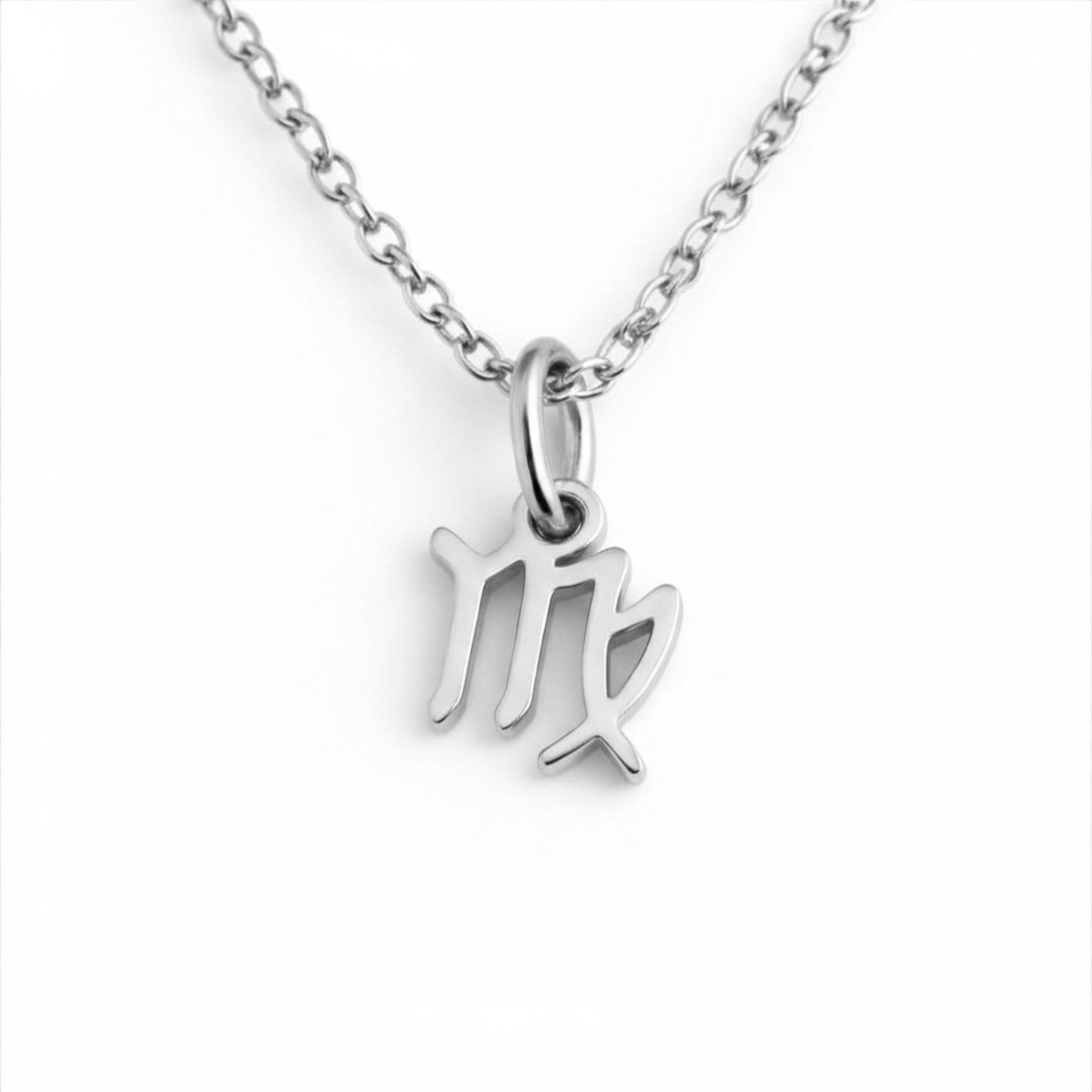 Virgo zodiac necklace silver pendant on silver chain close up