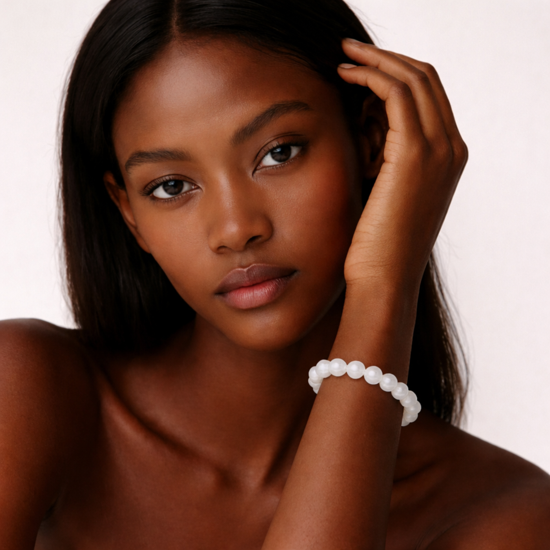 Woman wearing moonstone bracelet with white gemstone beads