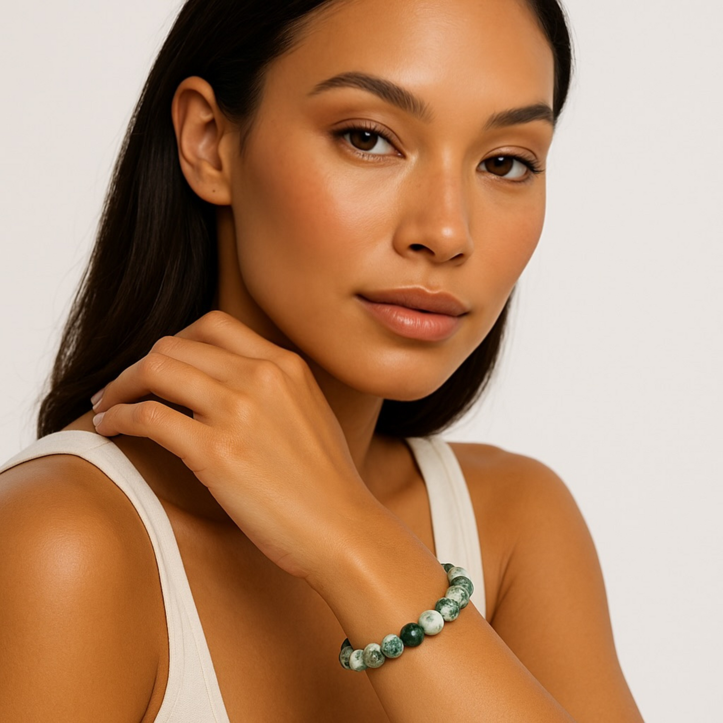 Woman wearing moss agate crystal bracelet with green and white gemstone beads
