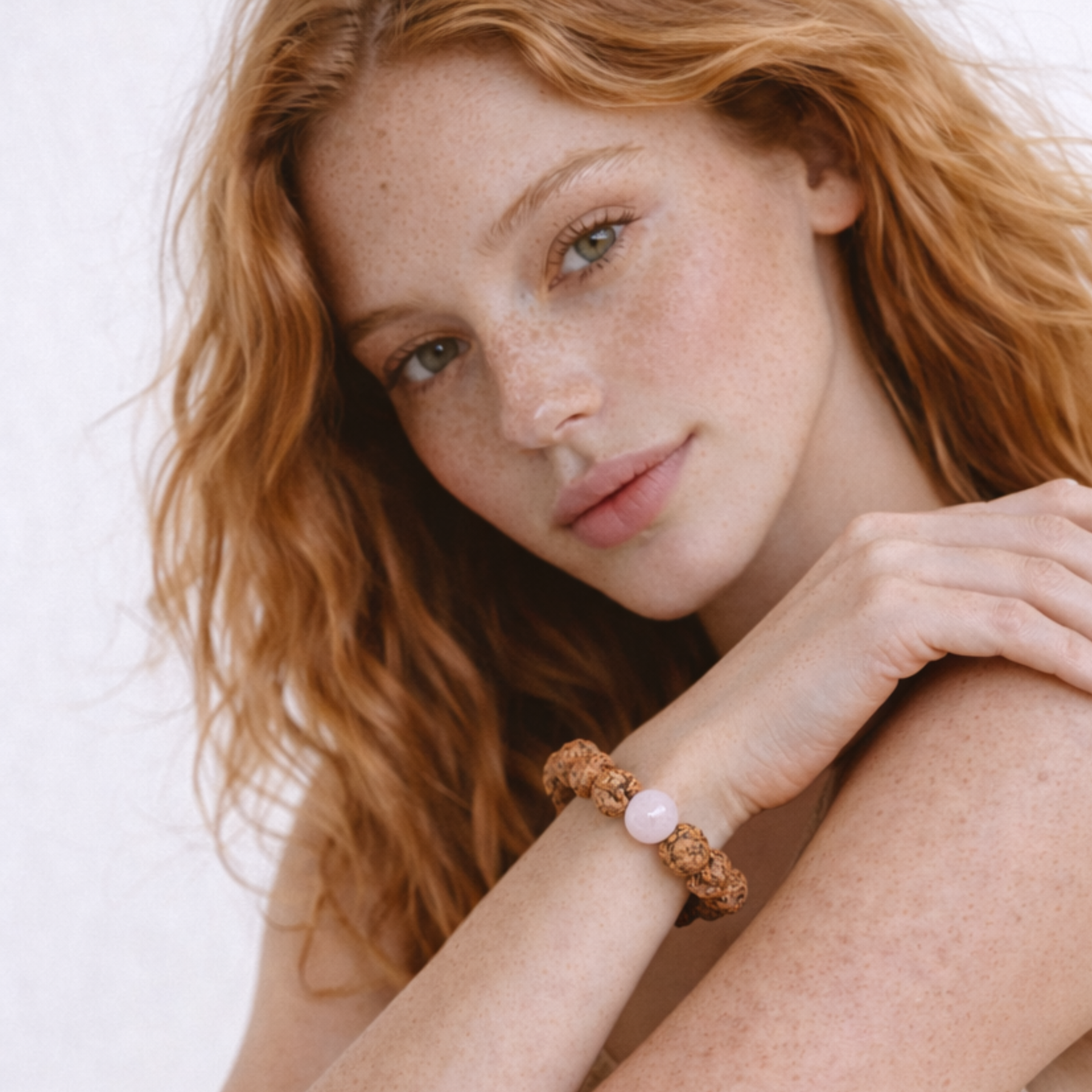 Woman wearing rudraksha and rose quartz protection bracelet