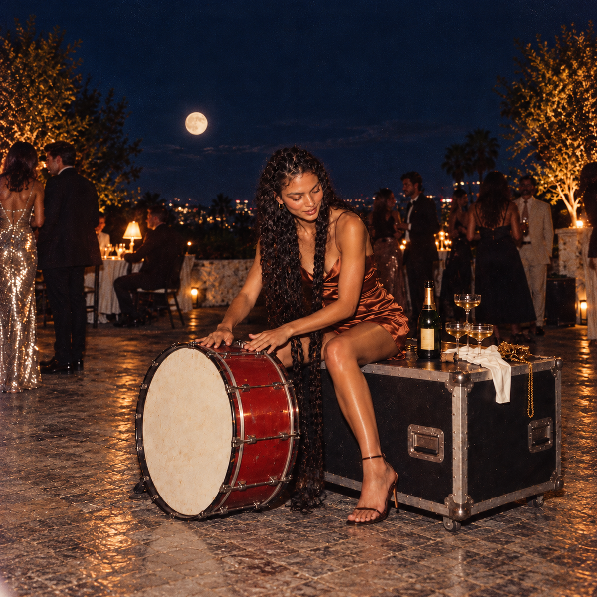 Woman with long dark braids in a copper satin dress playing a red bass drum at a moonlit rooftop party, with elegantly dressed guests in the background.